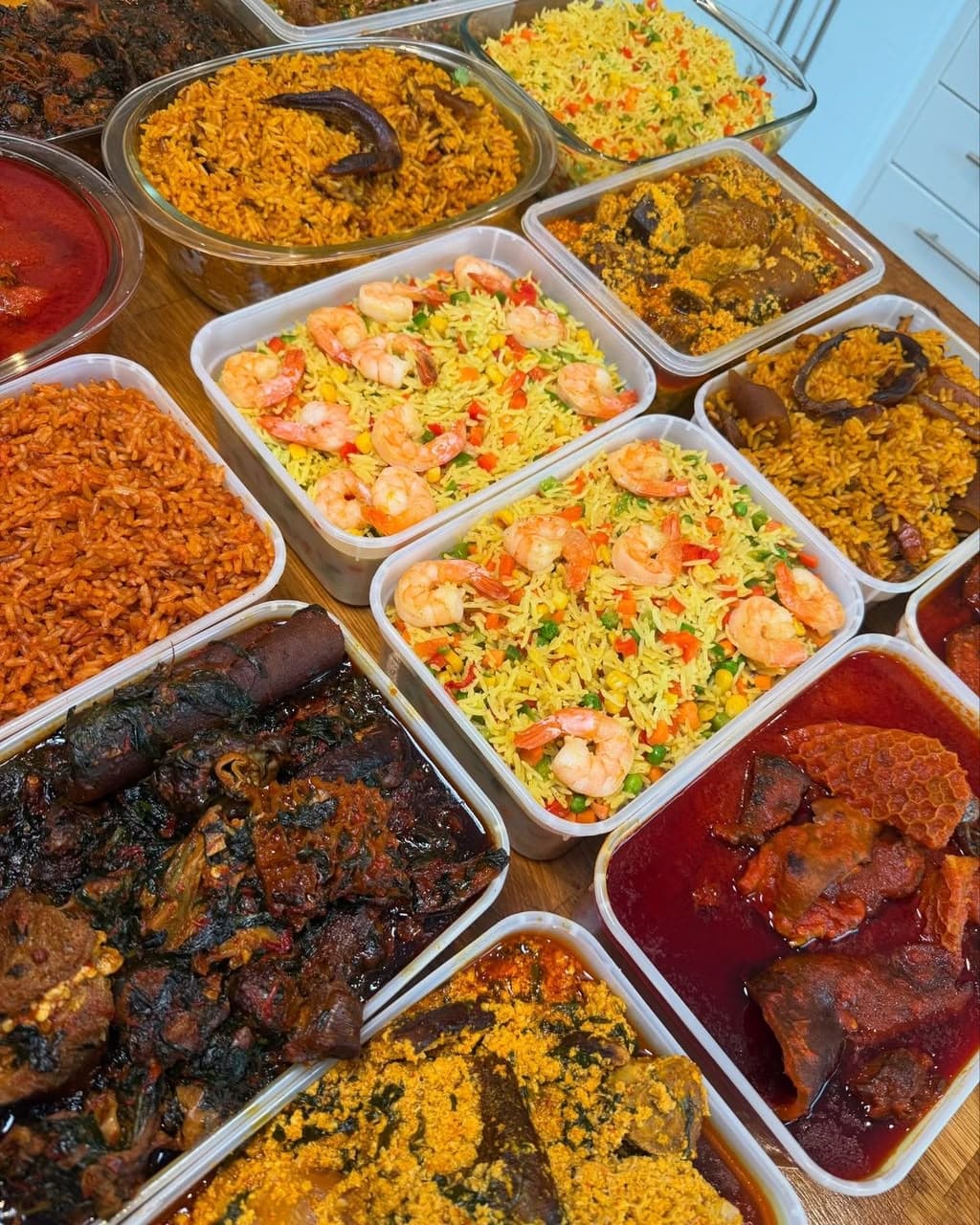 Containers of jollof and coconut rice prepared for an event